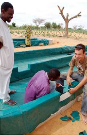 Men constructing a spirulina basin